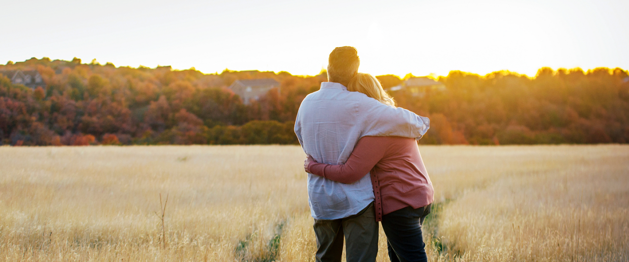 couple embracing outdoors at sunrise