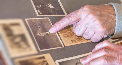 hands pointing at a photo in a family album