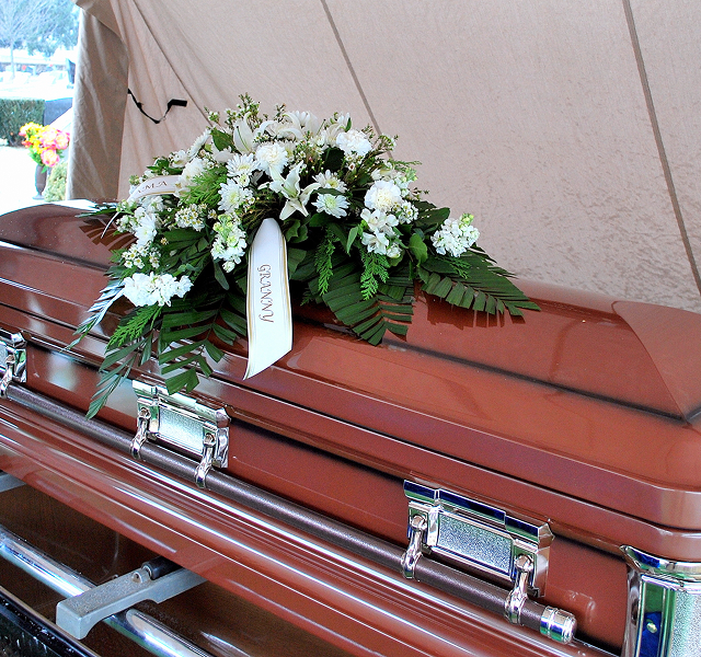 coffin with bouquet of flowers 