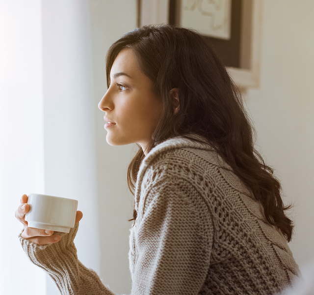 woman reflecting quietly by a window